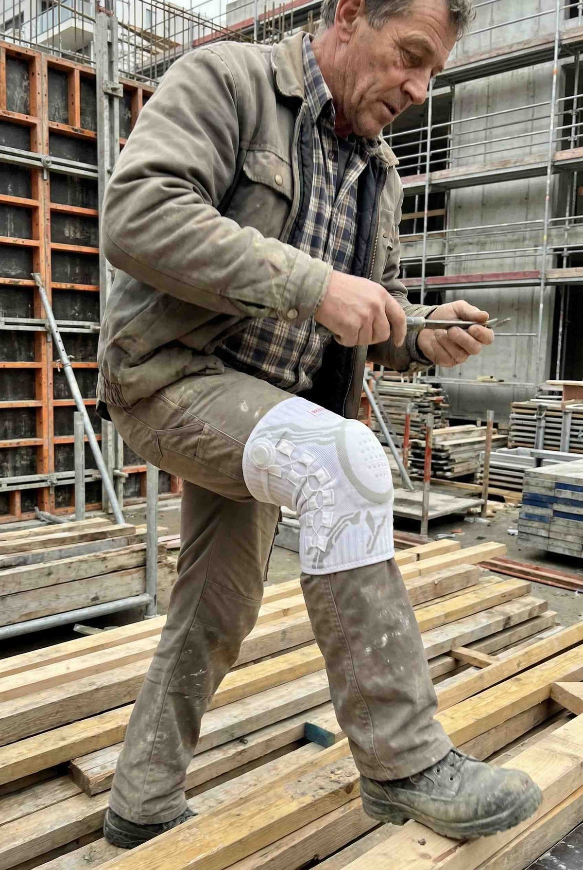 Working on a job site wearing the knee brace